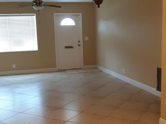 NEUTRAL TILE ON THE DIAGONAL. LAMINATE IN THE BEDROOMS
