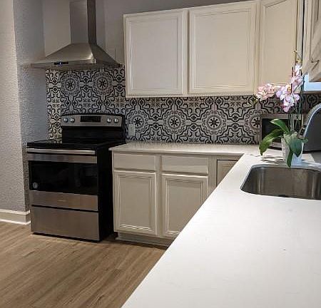 Kitchen with new floors and backsplash