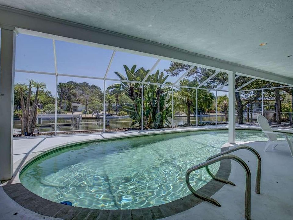 Stunning free form swimming pool with stainless cable fencin