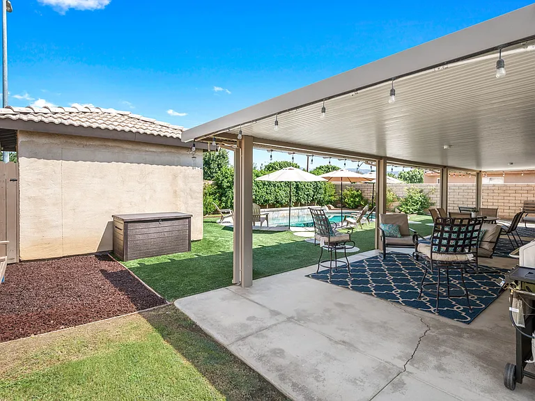 side of grass area next to outdoor patio