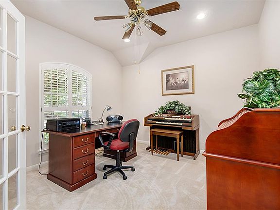 Fabulous home office with plantation shutters and French doors for added privacy.