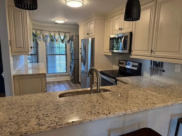 GREAT stainless appliance package and luxury stackable full size washer/dryer. Renovated kitchen, abundant storage, granite counters.