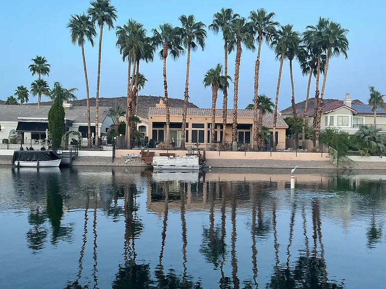 Palm Tree Paradise. Love the reflection of the trees on the lake. Check out the bird hanging out on the bouy. Pontoon Boat does not come with the house.