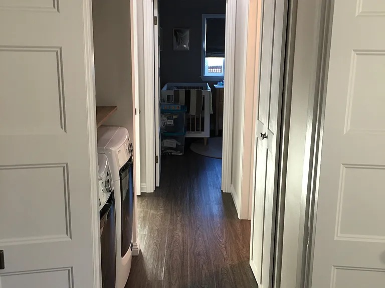 Hallway with laundry and storage