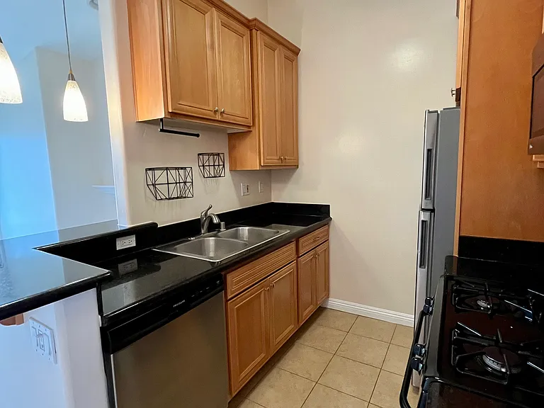 Sleek kitchen with granite counters, gas range, and dishwasher _ ready for all your culinary adventures