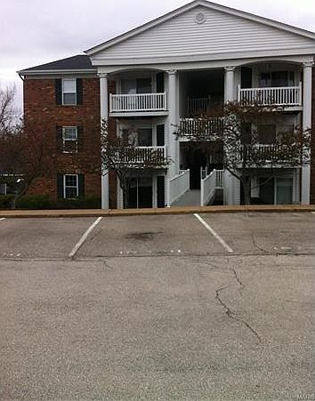 Front of building across from parking spaces.