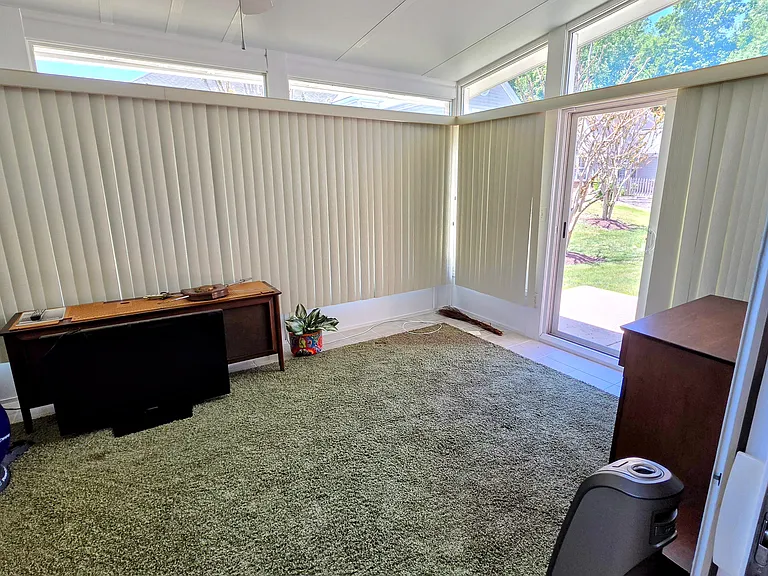 Panoramic windows frame this versatile bonus room, bringing the beauty of the outdoors inside.
