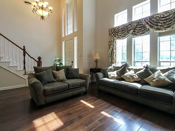 Dramatic entryway with a wall of windows and updated chandelier.