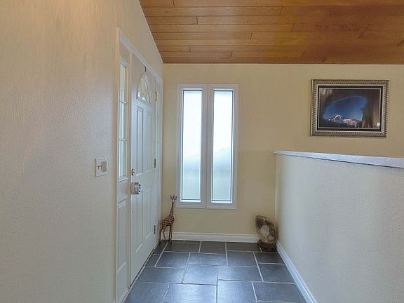 Welcoming slate floor entry leads you into this invitingly cozy home with a full wall stone fireplac