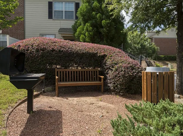 Quiet grilling nook surrounded by lush greenery