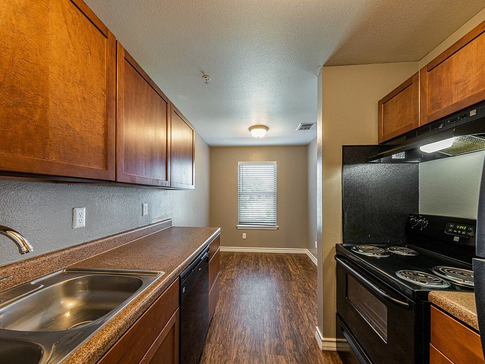 A spacious kitchen with warm wood cabinetry and ample counter space