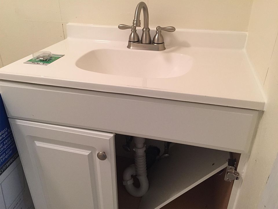 Cabinet being installed; door just needs to be put on. New vanity and faucet!