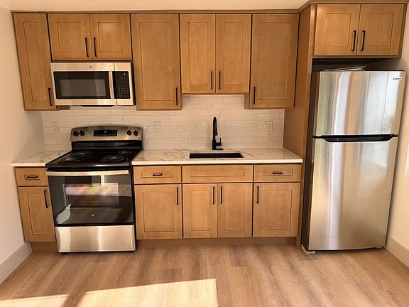 kitchen - wood cabinets, quartz countertop, stainless steel appliances