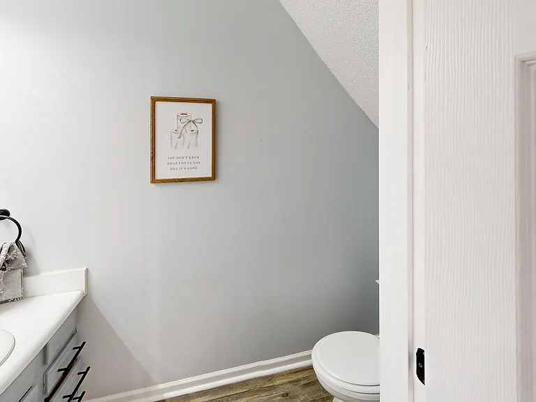 Downstairs half bath shown. Photo is of a similar unit; available unit shares the same floorplan. Fixtures only_furniture and decor not included.