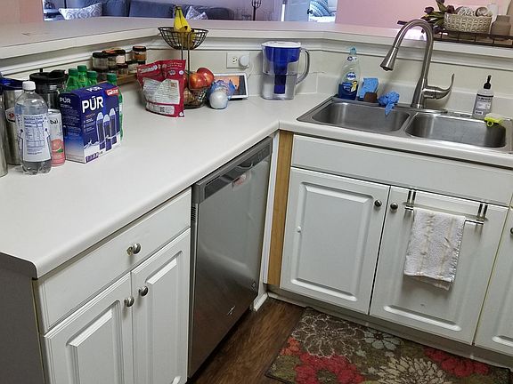 High arched faucet with detachable hose makes washing pots and pans a cinch. New dishwasher has in-door utensil holder.