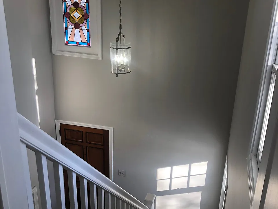 Front entry featuring the original stained glass window.