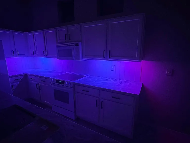 kitchen under cabinet mood lighting after remodel controled from phone app; many colors and patterns to choose from