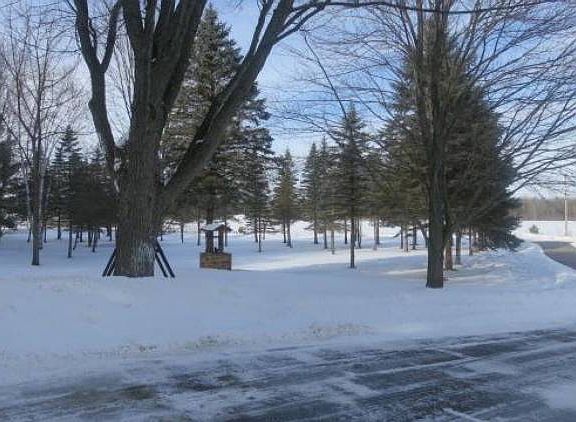 Beautifully wooded setting with paved driveway all the way back.