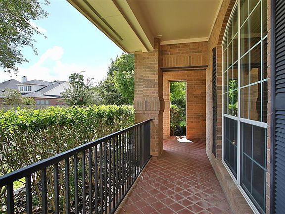 Let's sit and visit with the neighbors on the large covered porch with iron fence.