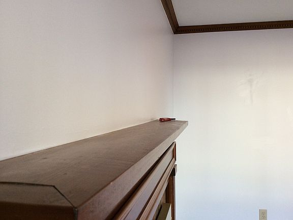 Wood fireplace mantel in living room.