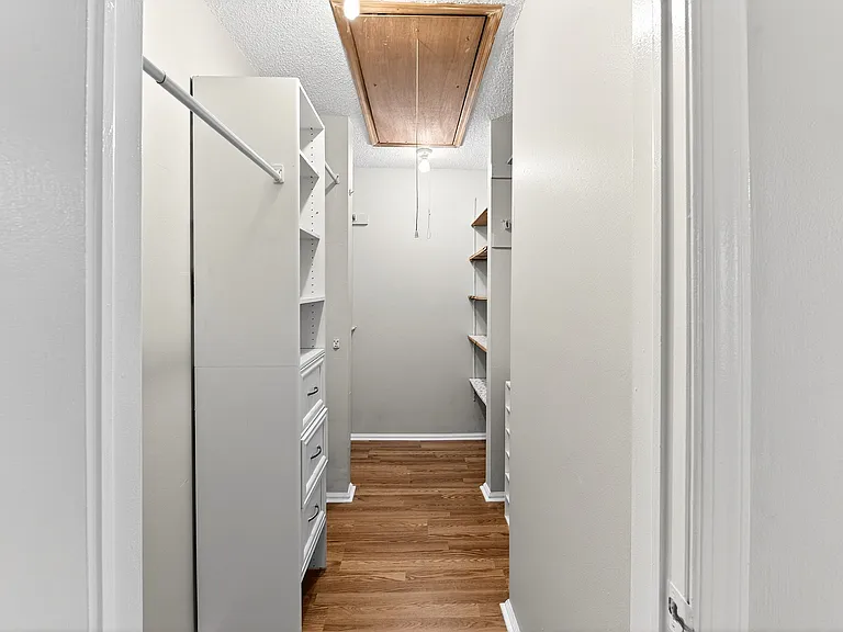 Primary bedroom walk in closet
