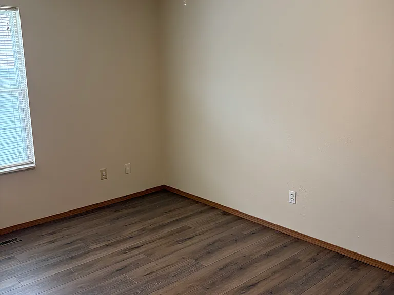 Guest bedroom showing new light and fan, flooring, new blinds. Walk-in closet is on the left not shown