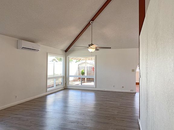 Enter to the open living space with vaulted ceilings