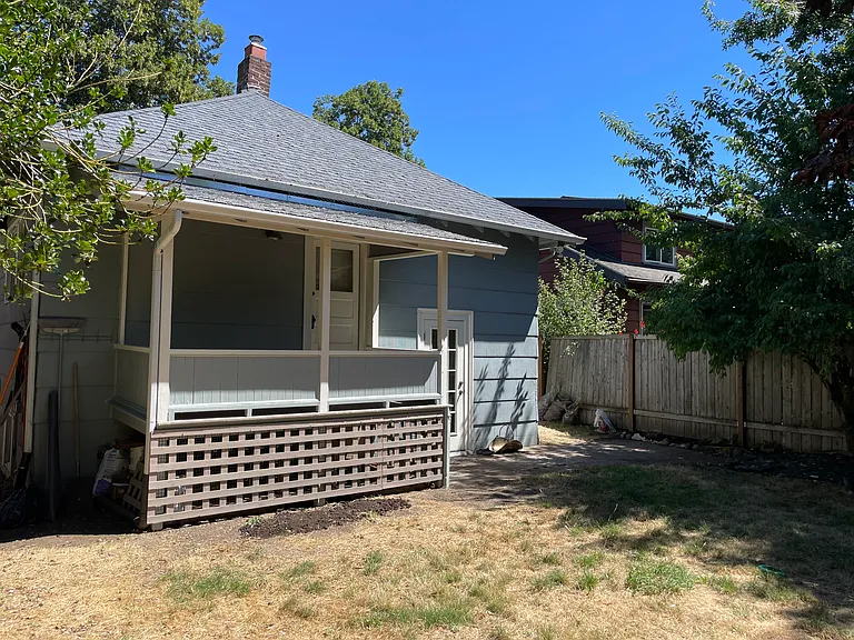 Covered kitchen porch overlooking back yard.