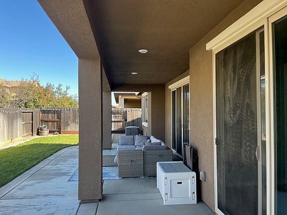 covered patio with (2) slider patio doors leading into both family room and master bedroom