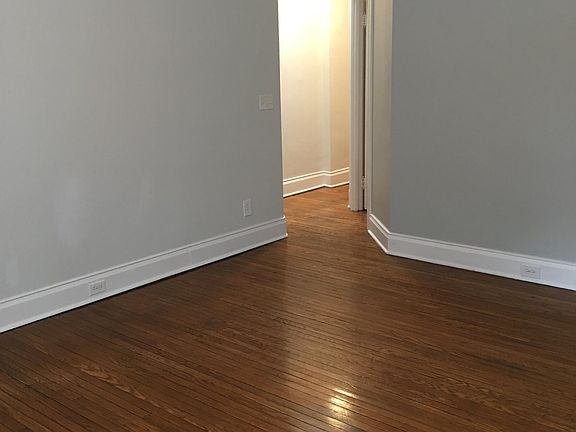 Living Room looking toward hallway when unfurnished; this room has three windows (not shown)