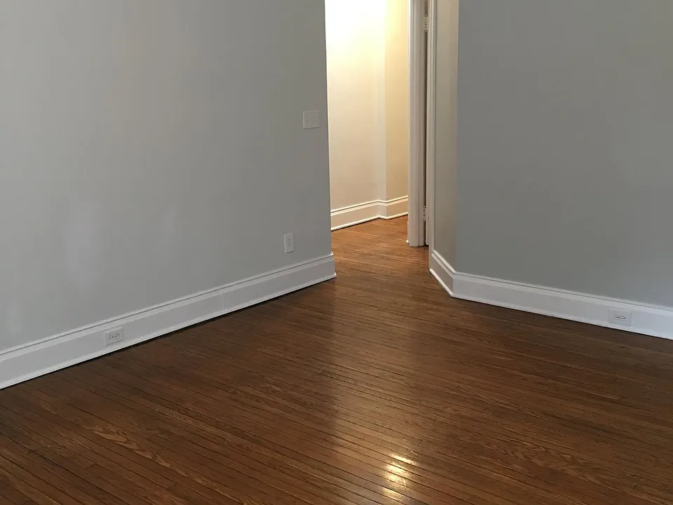 Living Room looking toward hallway when unfurnished; this room has three windows (not shown)