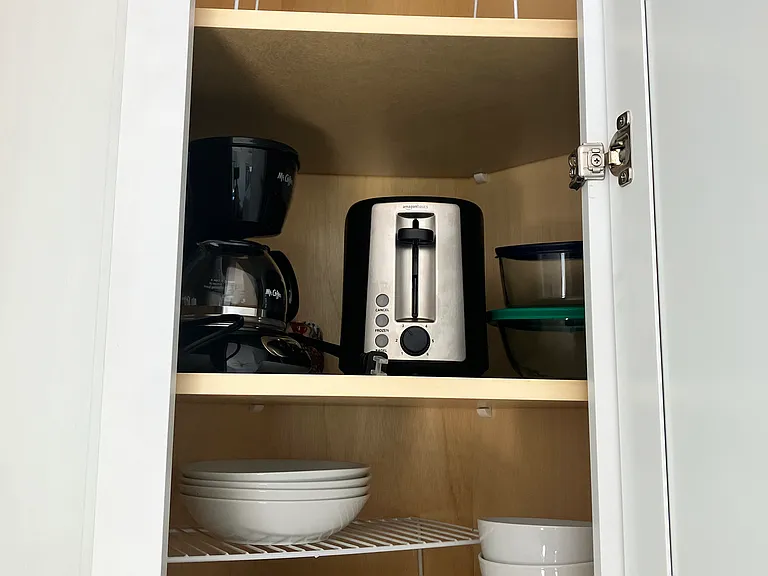 Coffee maker, toaster, plates and bowls are included.