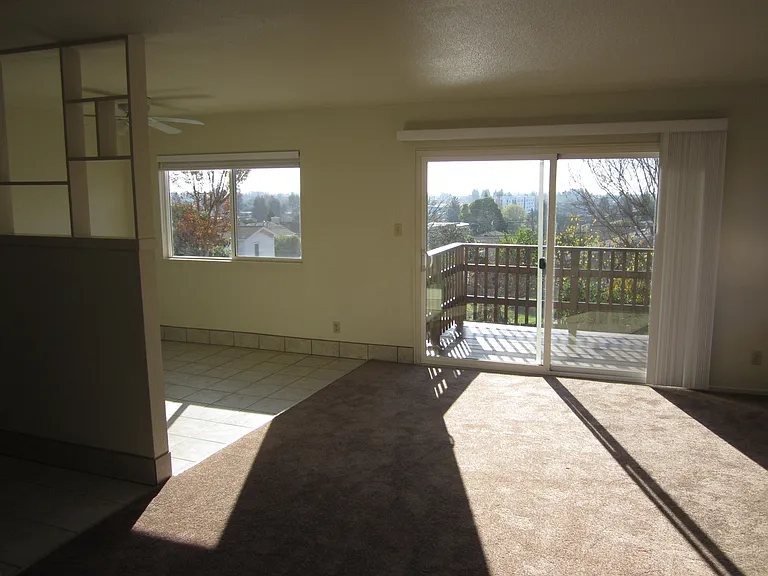 Exit dining room to over-sized living room to met all your relaxation needs with patio door to balcony with view.