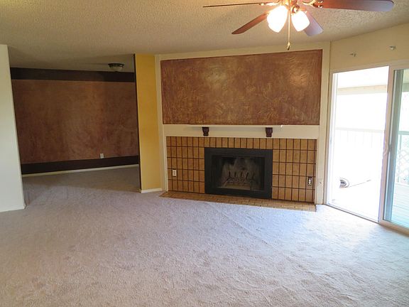 Wood burning fireplace in the living room. Walkout to private balcony with extra storage closet