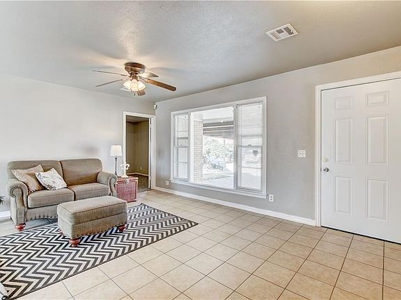 Large picture window, infuses natural light throughout the living space.