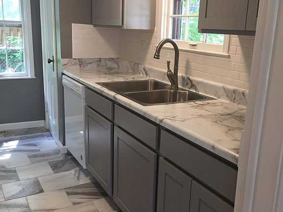 Newly remodeled kitchen - cabinets, appliances, countertop, sink and floor