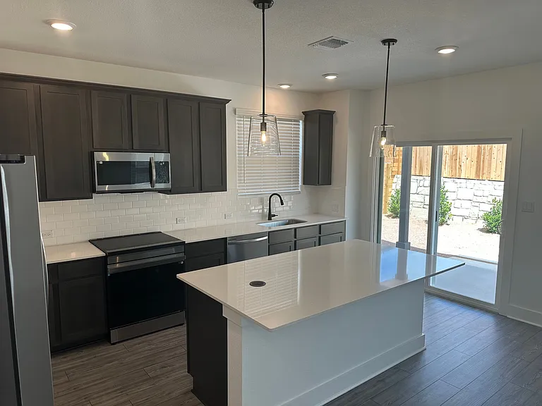 Kitchen with solid surface countertops and stainless steel appliances