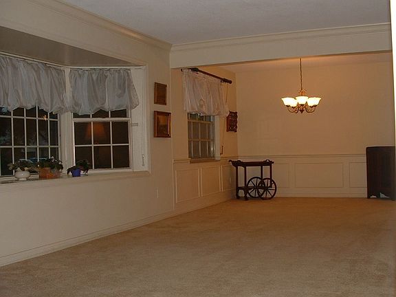 Huge formal living/dining room with a picturesque bay window.
