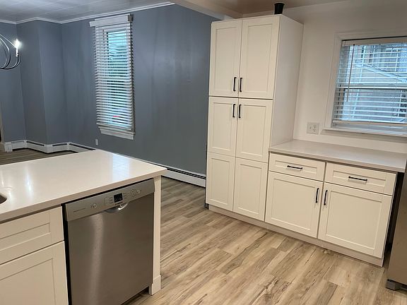 Bright and Open Kitchen with Newer Appliances and Island to Dining Area