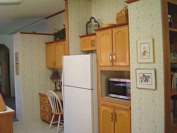 Kitchen has oak cabinets and a desk