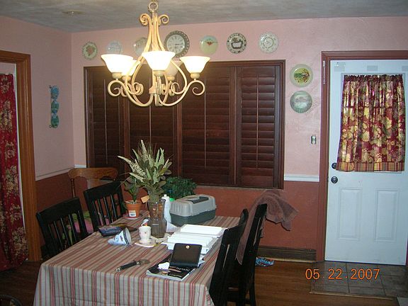 Dining room with matching cherry wood shutters