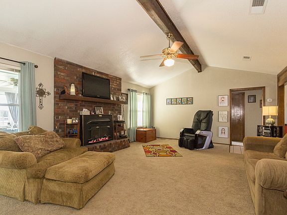 Large Great Room, with vaulted ceiling, woodburning stove.
