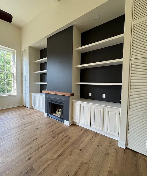 Fireplace wall. Focal point and storage closets on both sides