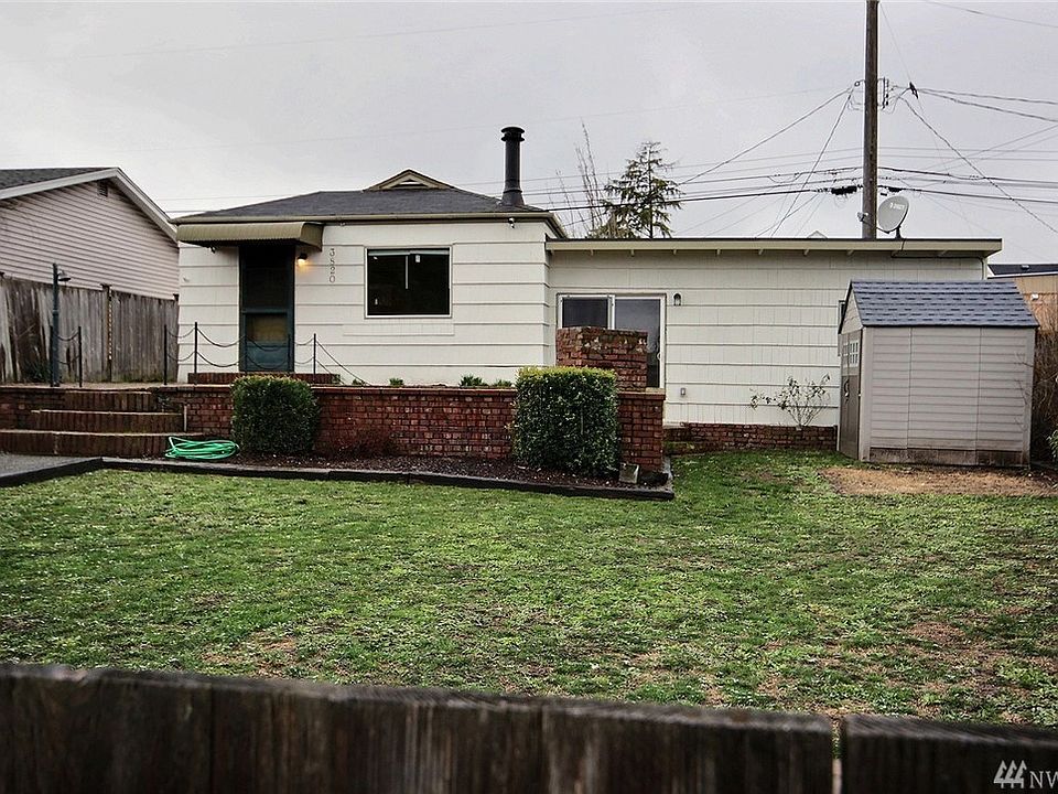 Home sits back off the road with a large yard and patio.