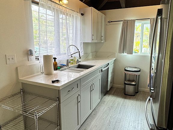 kitchen with updated GE appliances: dishwasher, full fridge, oven, stove, microwave