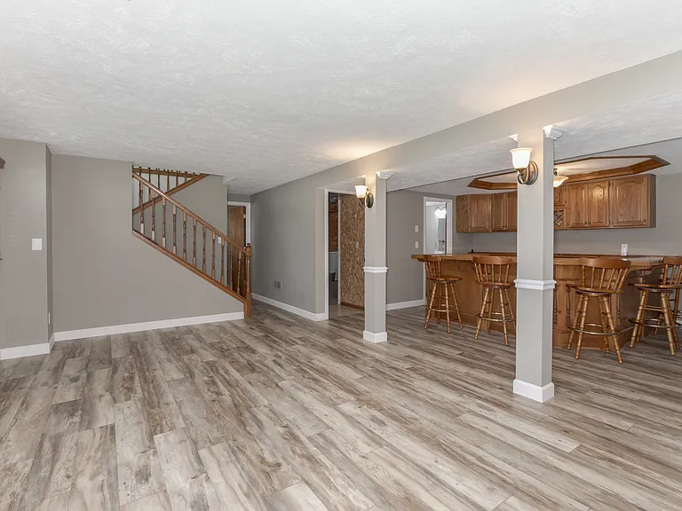 Lower level - excellent entertainment area. All new flooring and paint, bar makes for a great social space. Barstools included!