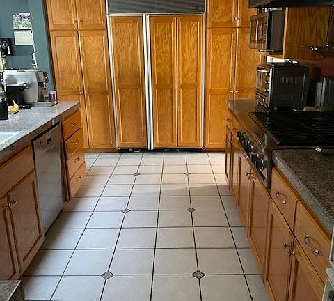 Large, 4', Sub-zero Refrigerator/Freezer with automatic ice maker. Floor to ceiling pantry cabinets on both sides.