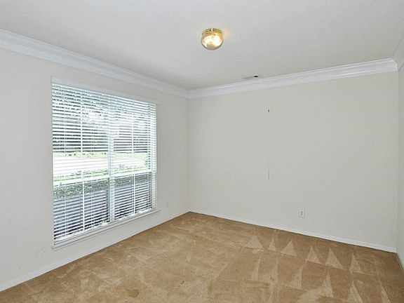 FORMAL LIVING ROOM IS RIGHT OFF OF THE ENTRY AND HAS A GREAT PICTURE WINDOW! IT IS CARPETED FLOORING