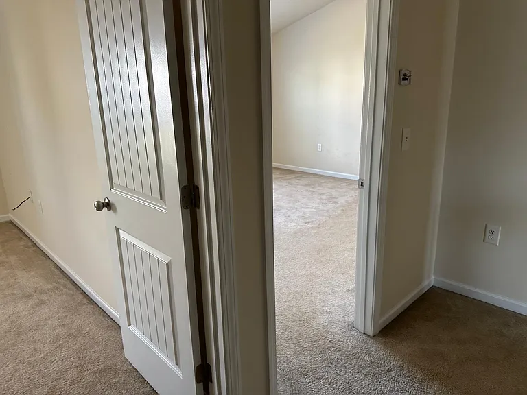A view from immediately outside the laundry room , where to the far left is bedroom 1, and to the right is the main bedroom.
