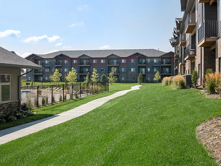 Green lawn next to apartments and clubhouse at Avenue 204.